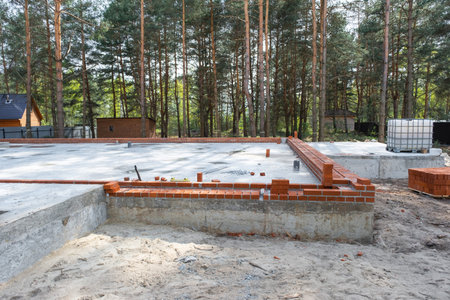 Concrete slab of foundation of house with laid pipes start of construction on project. Construction...