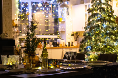 Festive interior of house is decorated for Christmas and New Year in loft style with black stove, fireplace, Christmas tree. Warm studio room with set table, burning wood, cozy and heating of homeの写真素材