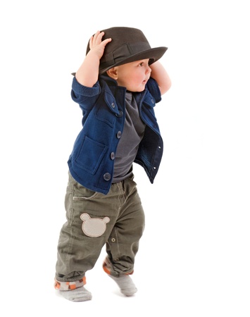 the little boy tries on a father s hatの写真素材