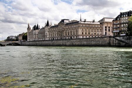 A view of the Conciergerie in Paris across the river Seineの写真素材
