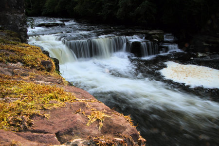 A view of a waterfall at the Falls of Clyde in Lanark in Scotlandの写真素材