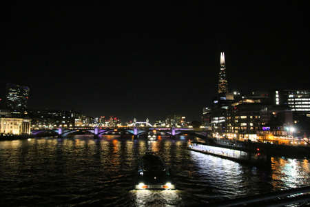 A view of the River Thames in London at nightの写真素材
