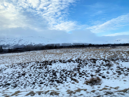 A view of the Iceland Countryside in the winter with snow and Ice on the groundの写真素材