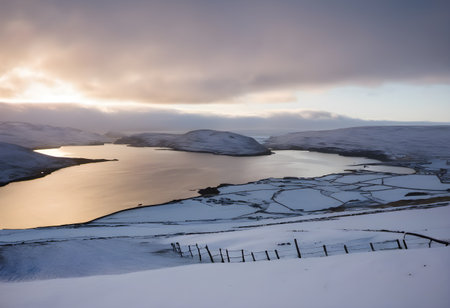 Icelandic winter landscape with snow covered fields and fjordの素材