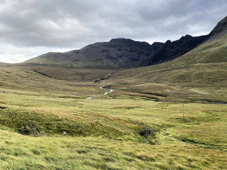 A view of a scenic landscape with a flowing river in the middle of a valley.の写真素材