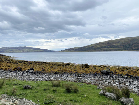 A view of a lake and mountains on a cloudy day