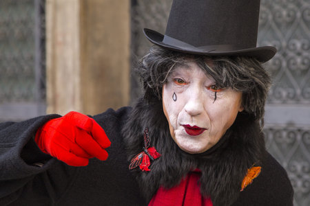 Venice, Italy - February 10, 2015: Single traditional Venetian mask on St. Mark's Square in Venice. Portrait of a man wearing a mask in Venice during the carnival days.のeditorial素材