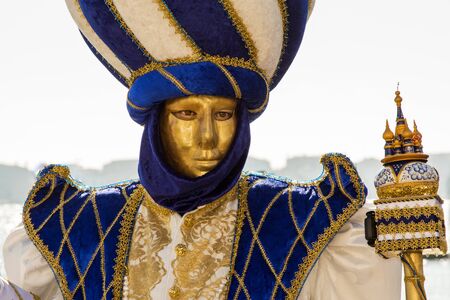 Venice, Italy - February 10, 2015: Single traditional Venetian mask on St. Mark's Square in Venice. Portrait of a man wearing a mask in Venice during the carnival days.のeditorial素材