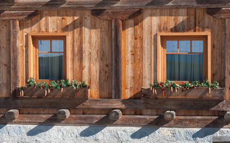 Two windows of a caratteristic and little house in Trentino Alto Adigeの写真素材