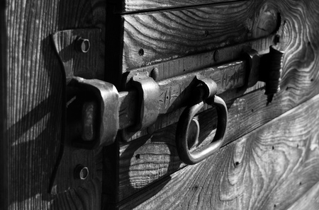 Old metal bolt of a wooden gate - old wooden doorの写真素材