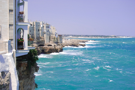 Overlooking the sea of Polignano a Mare with white houses and rough seaの写真素材