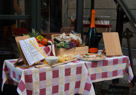 Menu with table set outside Italian restaurant - Milanの写真素材