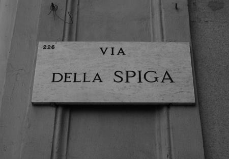 Municipal marble plaque engraved with the writing of della Spiga street in Milan - Italyの写真素材