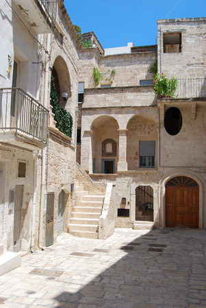 Typical courtyard among the white houses with  flowers and plant in Polignano a Mareの写真素材