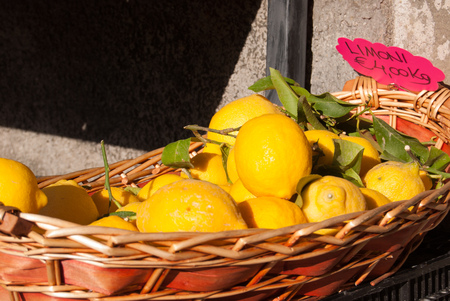 Lemons fruits in a natural wicker basketの写真素材