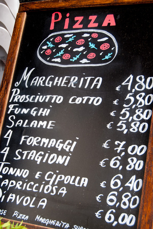 Menu on blackboard with prices outside Italian cafeの写真素材