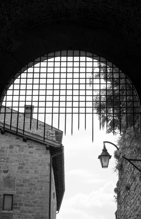 View of iron gate of Town Hall in the medieval city of Gubbio from insideの写真素材