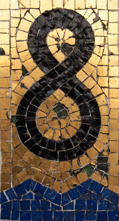 Eight in gold and black mosaic on a wallの写真素材