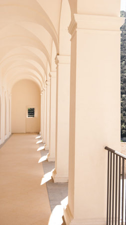 Colonnade of light pink color of a covered passage in Spoleto