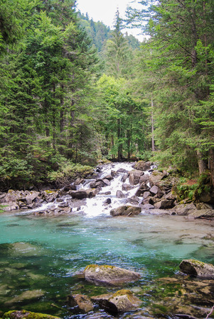 Waterfall in the midst of unspoiled nature in Nambrone valley close to Madonna di Campiglioの写真素材