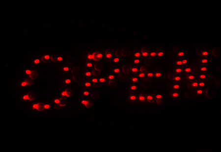 Red light written Open outside a restaurantsの写真素材