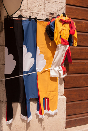 Selling flags and dresses exposed outside of a souvenir shopの写真素材