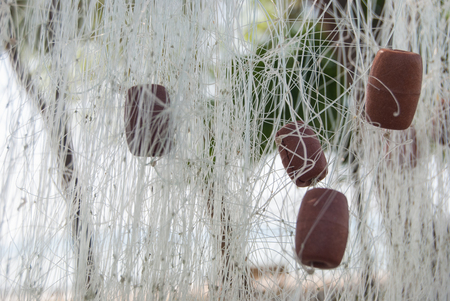 Nets of fisherman hunging for drying after fishingの写真素材
