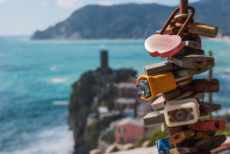 Pile of rusty padlocks as love promise with the sea and castle in Vernazzaのeditorial素材