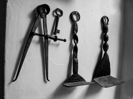 old metal work tools hanging on the wallの写真素材
