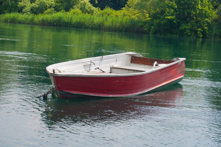 Rowing boat tied at the bank of the riverの写真素材