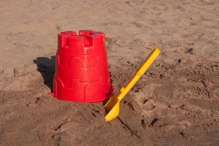 Red bucket and yellow scoop for childrenの写真素材