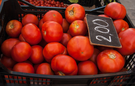 Box full of ripe and fresh little tomatoesの写真素材