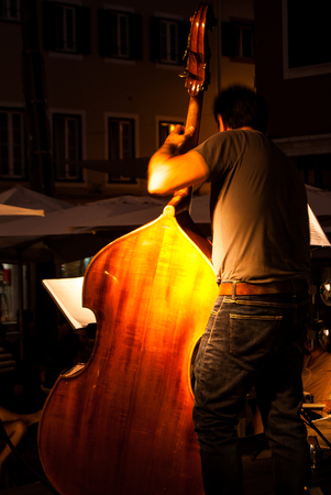 Musician playing the double bass during a concert in the open airの写真素材