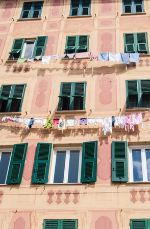 Typical and colorful house with with clothes drying at the open air in Camogli