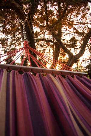 A colorful and comfortable hammock during the sunsetの写真素材