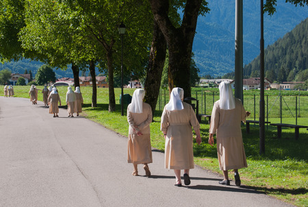Groups of sisters walking and chatting to each otherの写真素材