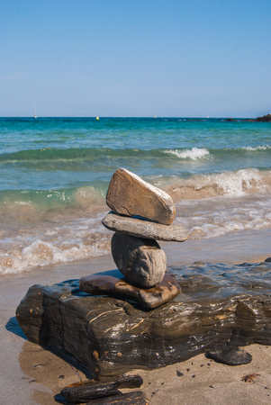 Pyramid of stones on the beach and clear skyの写真素材