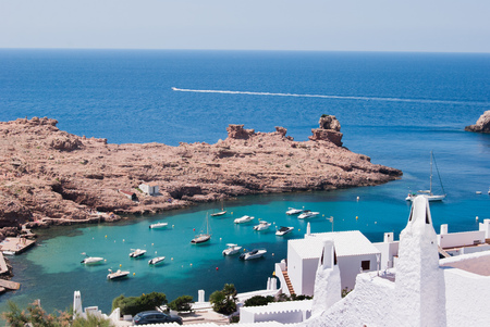 Port with crystalline sea and red rocky cliffの写真素材
