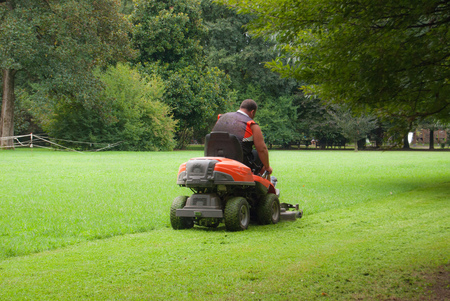 Man at work while sitting on a lawnmowerの写真素材
