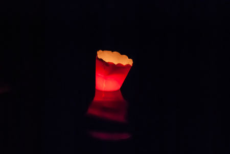 Little and colorful candle floating in the sea in the night during Maris star partyの写真素材