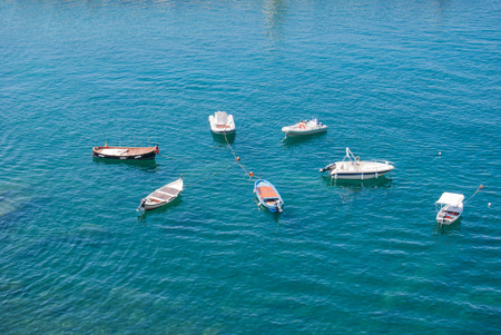 Boats arranged radially linked to buoys in the seaの写真素材