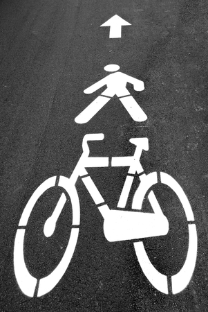 White road directions painted on black asphaltの写真素材