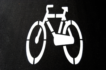 White road directions painted on black asphaltの写真素材