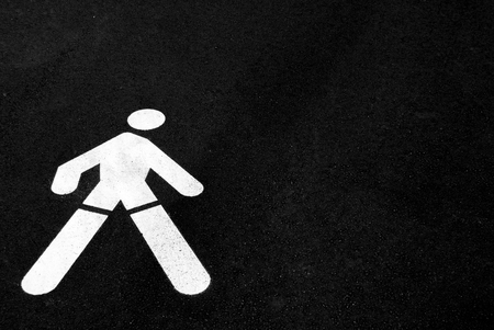 White road directions painted on black asphaltの写真素材
