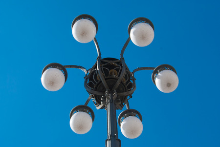 Typical street lamp in the Duomo square and blue sky of Milanの写真素材