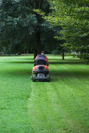 Man at work while sitting on a lawnmowerの写真素材