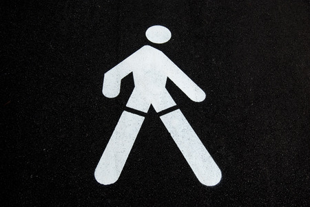 White road directions painted on black asphaltの写真素材