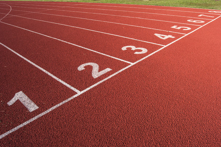 White lanes on the red carpet of the athletics ringの写真素材