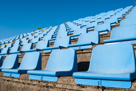 Light blue and plastic seats arranged in an amphitheaterの写真素材