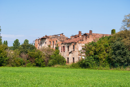 Old farm unsafe without roof and partially destroiyedの写真素材